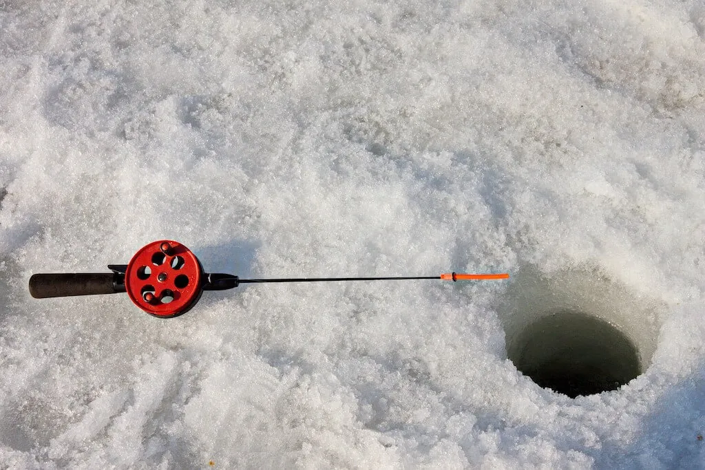 Ice Fishing Rod and Drilled Hole