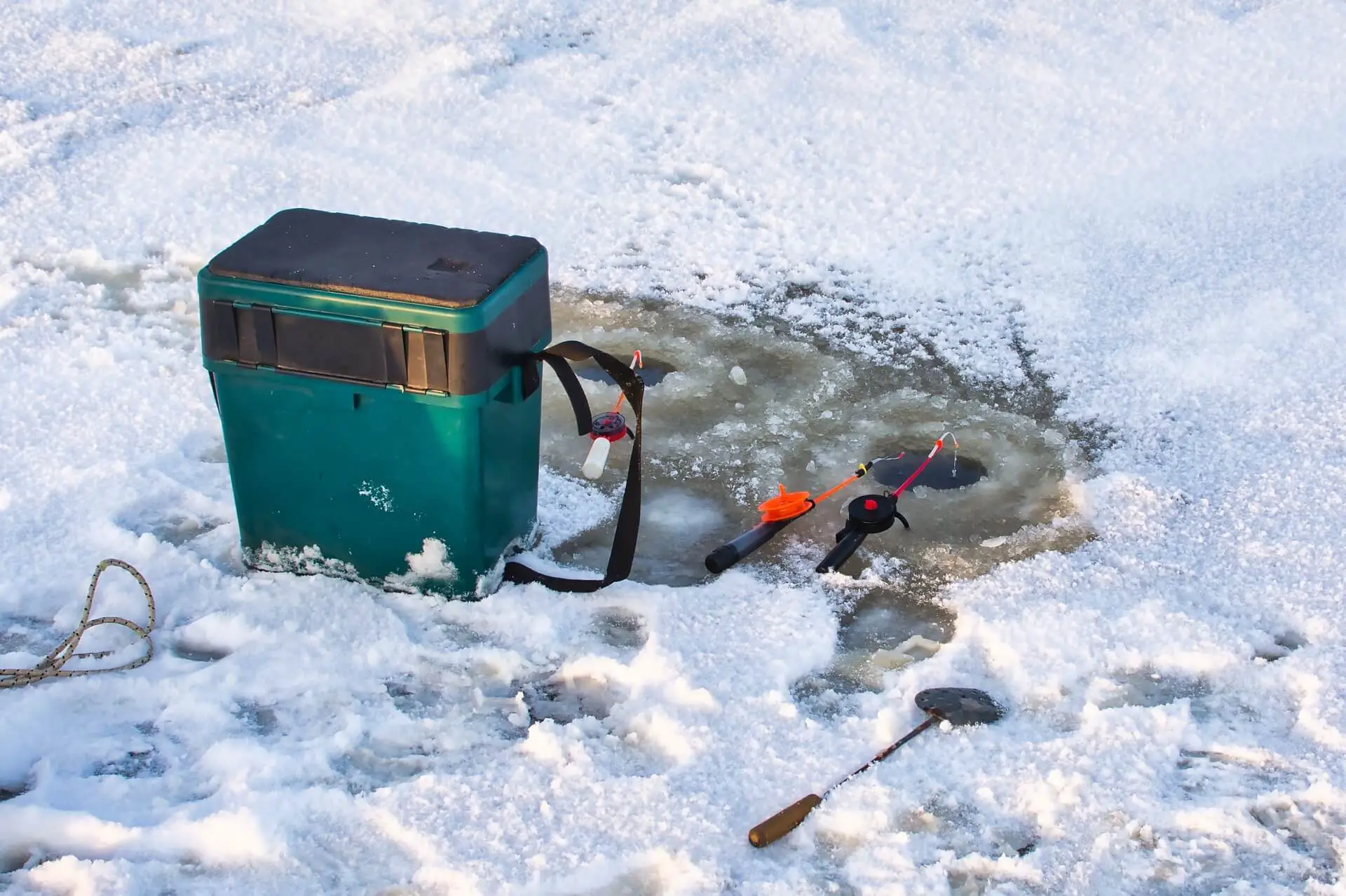 Ice fishing equipment with rods and  a cooler