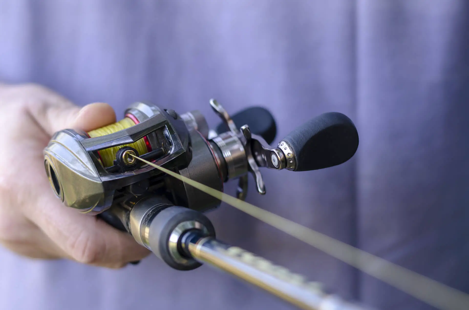 Best Baitcasting Reels Review: Man holding a baitcasting rod and reel
