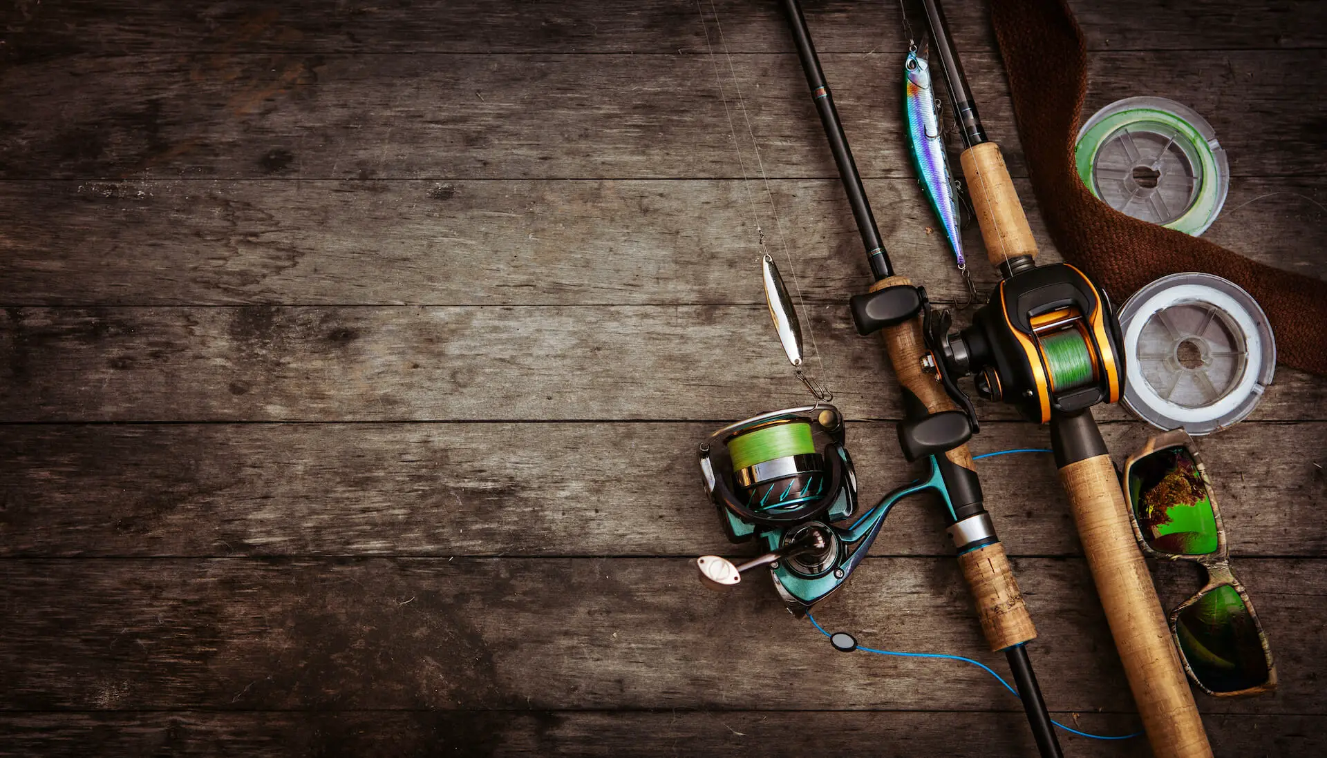 Spinning Reel and Baitcasting Reel on wooden floor: Review of the best baitcasting reel under 100