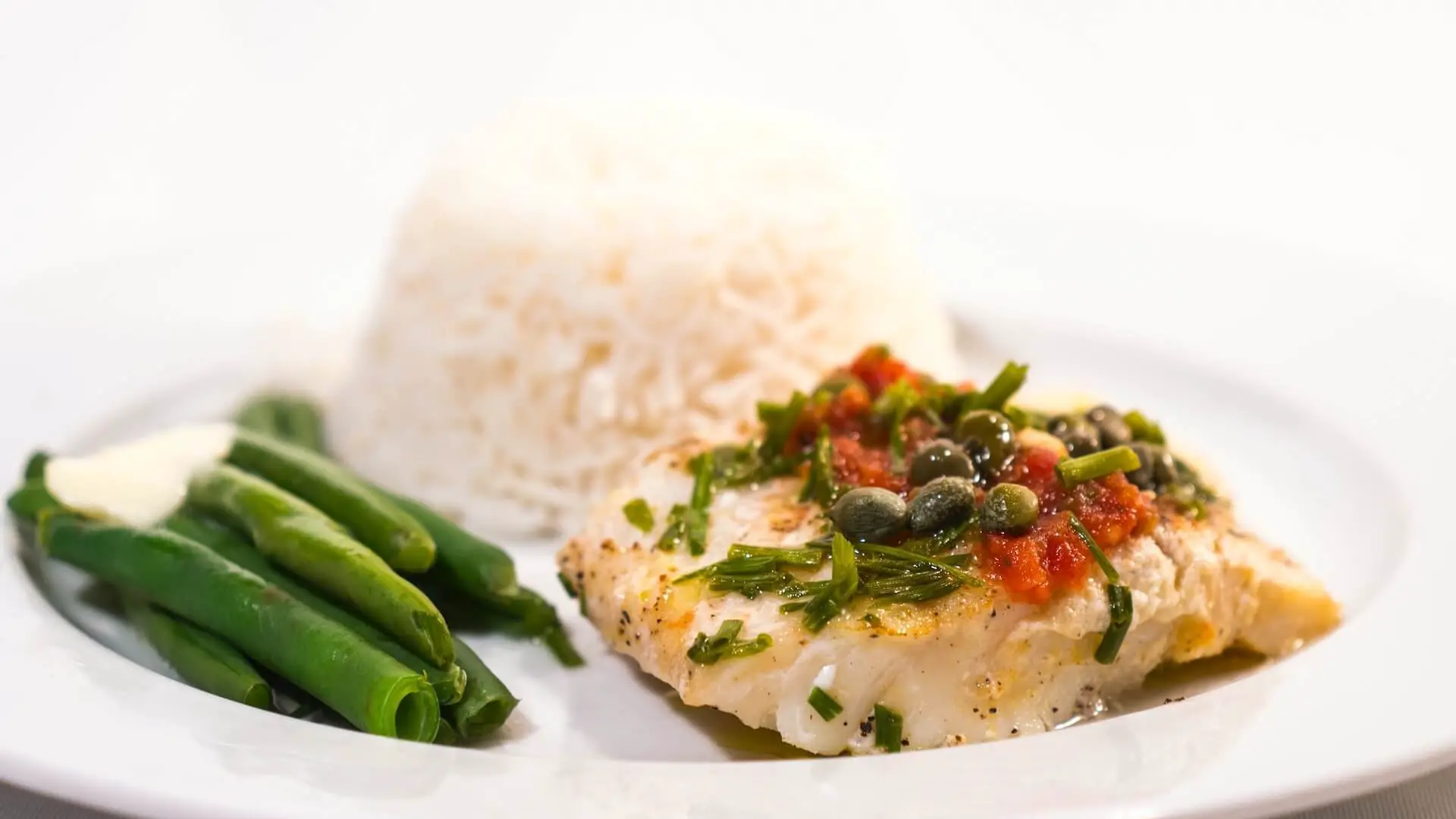 Cod on a plate with beans and rice